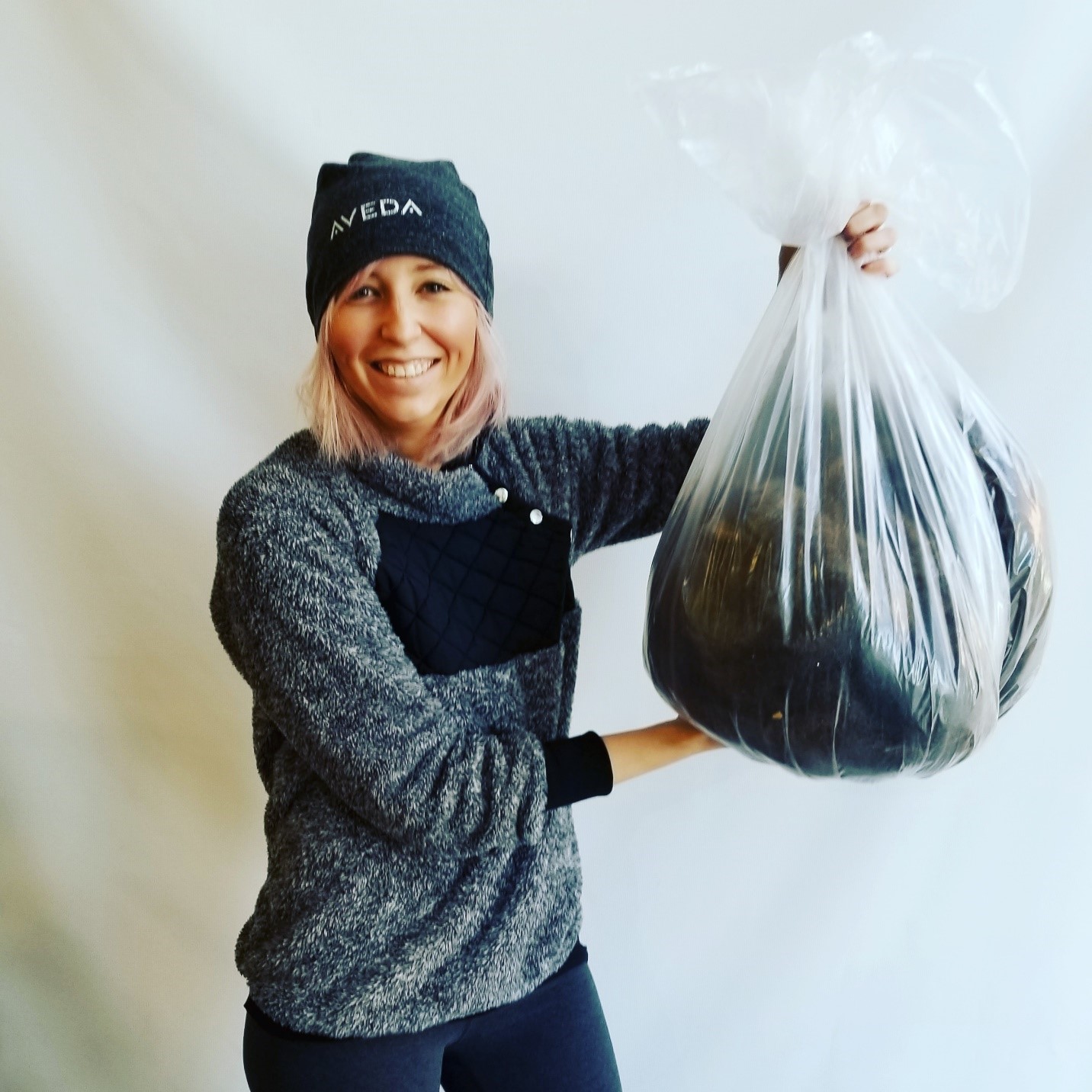 Stylist Cassie Roland, holding a bag of hair to be recycled, brought the idea of partnering with Green Cycle to Nostallja Studio.